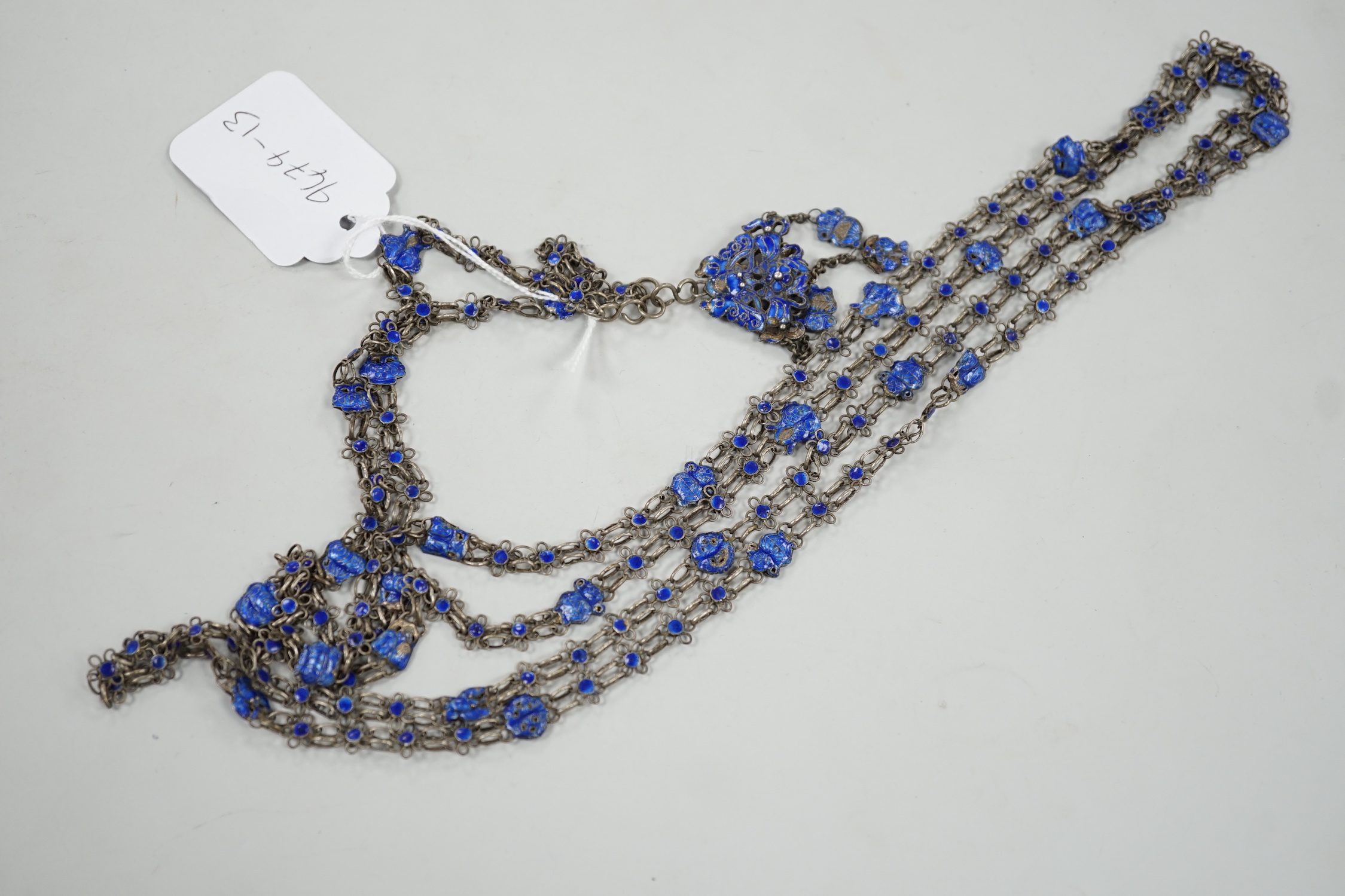 A long Chinese white metal and blue enamel set drop necklace, 204cm.